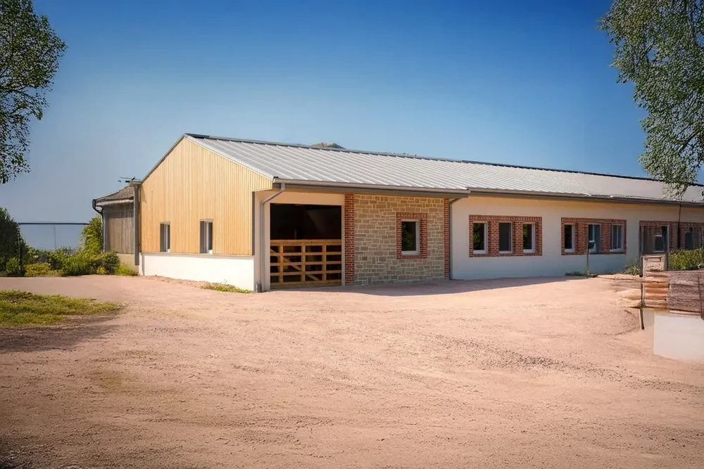 Bâtiment agricole moderne en construction mixte, situé en zone rurale sur terrain de terre battue